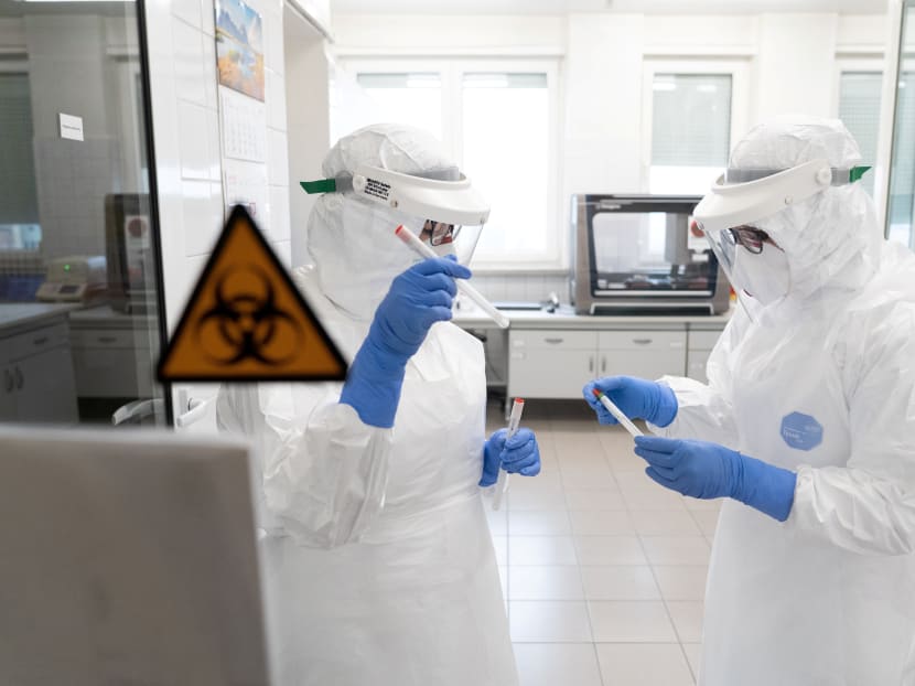 Workers wearing protective suits at a laboratory which performs diagnostic tests for Covid-19 in Olsztyn, Poland, on March 12, 2020.