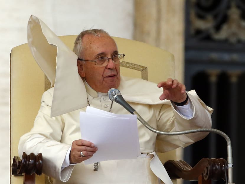 A gust of wind blows Pope Francis' mantle as he speaks during his weekly audience in Saint Peter's Square at the Vatican Nov 5, 2014. Photo: REUTERS