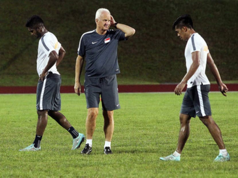 Bernd Stange between players Hariss Harun (left) and Khairul Amri at yesterday’s training session. Amri’s equaliser against Thailand on Sunday was the first goal scored by Singapore in a competitive match at the new National Stadium. Photo: Ooi Boon Keong
