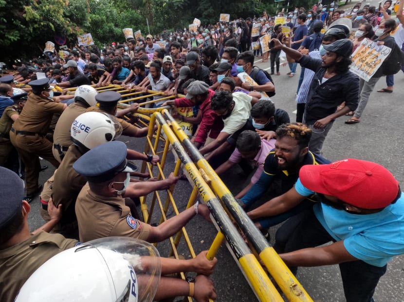 Protesting Sri Lankan university students, demanding the resignation of president Gotabaya Rajapaksa, clash with police officers near parliament in Sri Lanka's capital Colombo on May 4, 2022. Protesting Sri Lankan university students, demanding the resignation of president Gotabaya Rajapaksa, clash with police officers near parliament in Sri Lanka's capital Colombo on May 4, 2022.