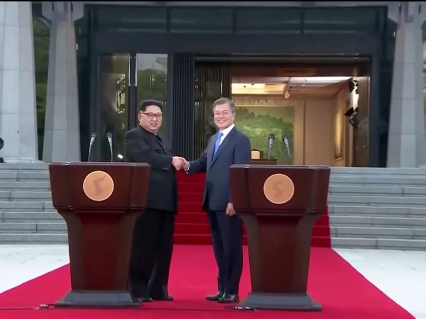 South Korean President Moon Jae-in and North Korean leader Kim Jong-un shake hands after delivering a joint statement during the inter-Korean summit at the truce village of Panmunjom. The two leaders agree to work to remove all nuclear weapons from the Korean Peninsula.