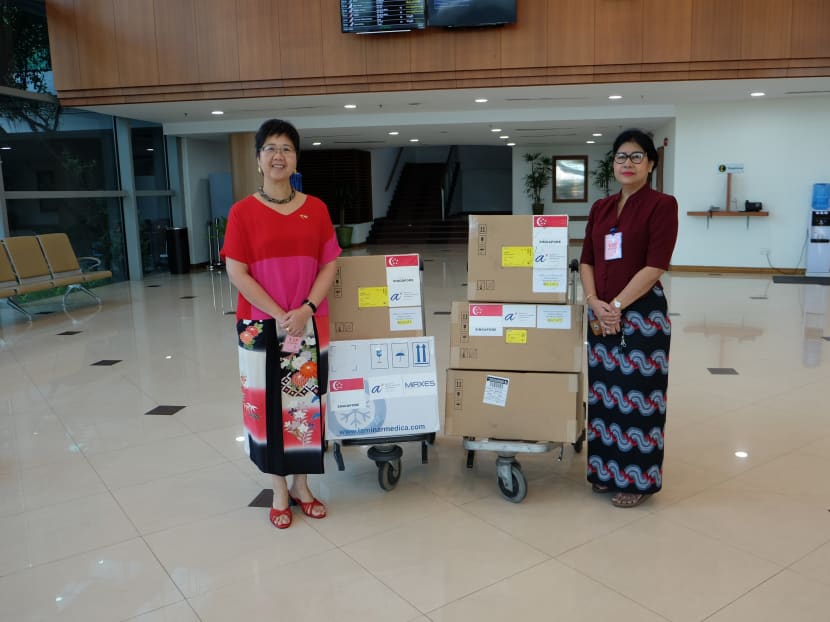 Singapore Ambassador to Myanmar Vanessa Chan (left), handing over Singapore’s contributions to the director of Myanmar national health laboratory Htay Htay Tin.