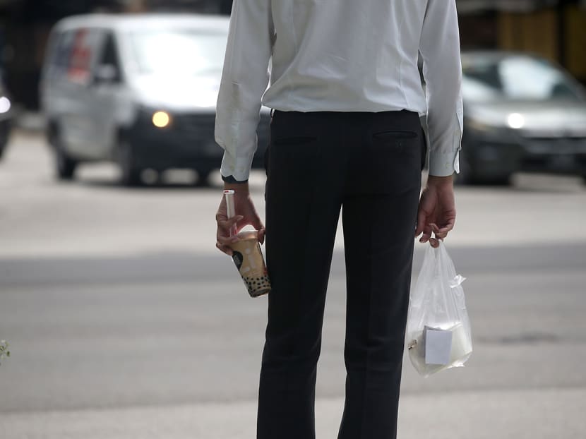 A worker in Singapore's Central Business District carrying packed food during lunch hour on May 20, 2021. A worker in Singapore's Central Business District carrying packed food during lunch hour on May 20, 2021.