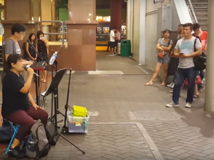 Tang Yuxuan busking a few weeks before her death in March this year. MP Louis Ng referred in Parliament to her difficulty in finding available busking sites given that she travelled with a wheelchair.