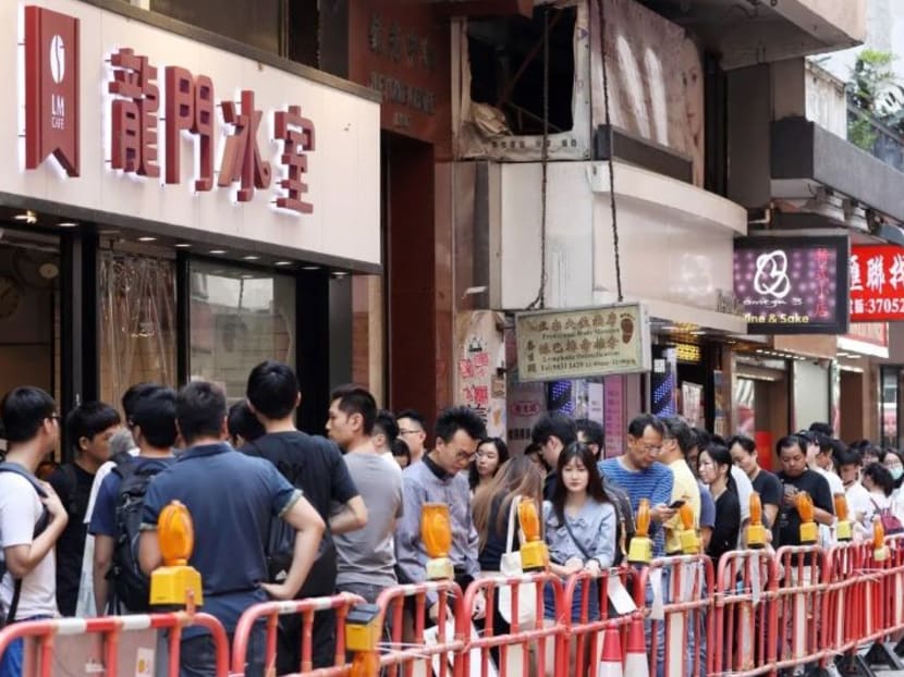 wds gather outside the Lung Mun Cafe in Hung Hom. Its owner supports the anti-government protesters.
