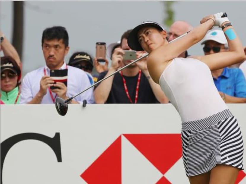 A determined Michelle Wie tees off at the 18th hole in the third round of the HSBC Women's Champions golf tournament at the Sentosa Golf Club. Photo: Getty Images
