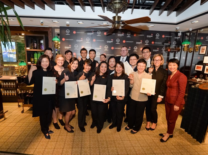 DFS Changi Whisky Ambassadors holding their certificates from The Whisky Ambassador. Photo: DFS Group