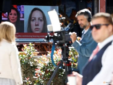 FILE PHOTO: Members of the media work near a large screen showing a picture of convicted hospital nurse Lucy Letby, ahead of her sentencing, outside the Manchester Crown Court, in Manchester, Britain, August 21, 2023. REUTERS/Phil Noble/File Photo