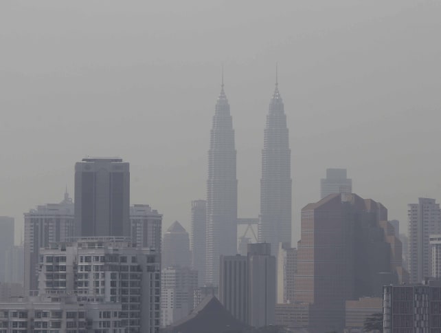 Malaysia's landmark Petronas Twin Towers and other buildings are covered by haze in Kuala Lumpur, Malaysia, Wednesday, on June 19, 2013. 
