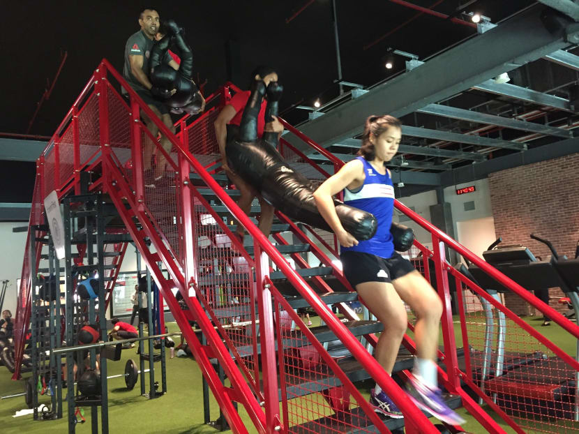 Participants carry dummies that weigh 32kg and 41kg across the Throwdown frame. The new structure is built for exercises such as lifting, pulling and climbing. Photo: Fitness First