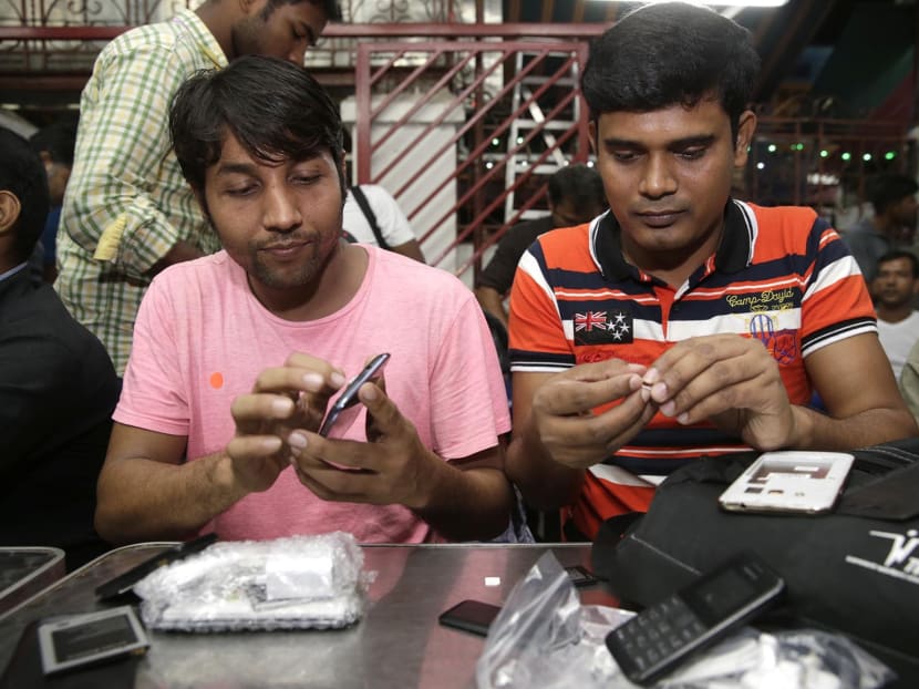 450 needy foreign workers set to get new phones ahead of 3G shift