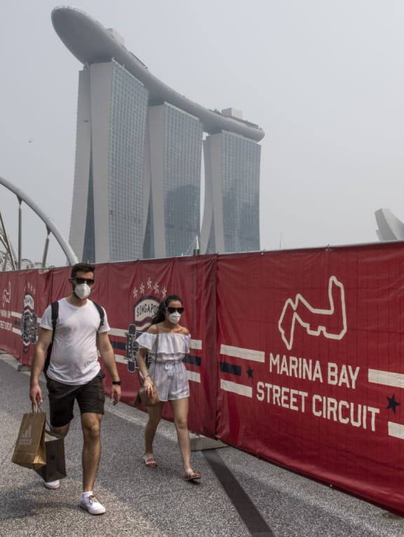 Tourists wearing protective masks as they walked near the Formula One race track while haze blanketed Singapore in September 2019. 