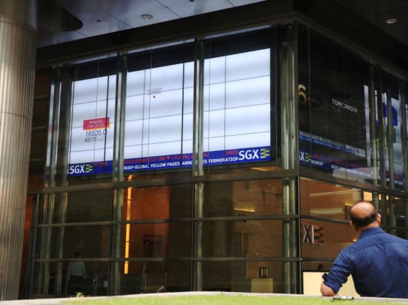 A man standing outside the Singapore Exchange building. Goh Hin Calm, the first of three people charged for orchestrating the largest case of stock-market manipulation in Singapore’s history, has been convicted and jailed.