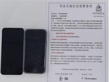 Two mobile phones and documents seized by the police. 