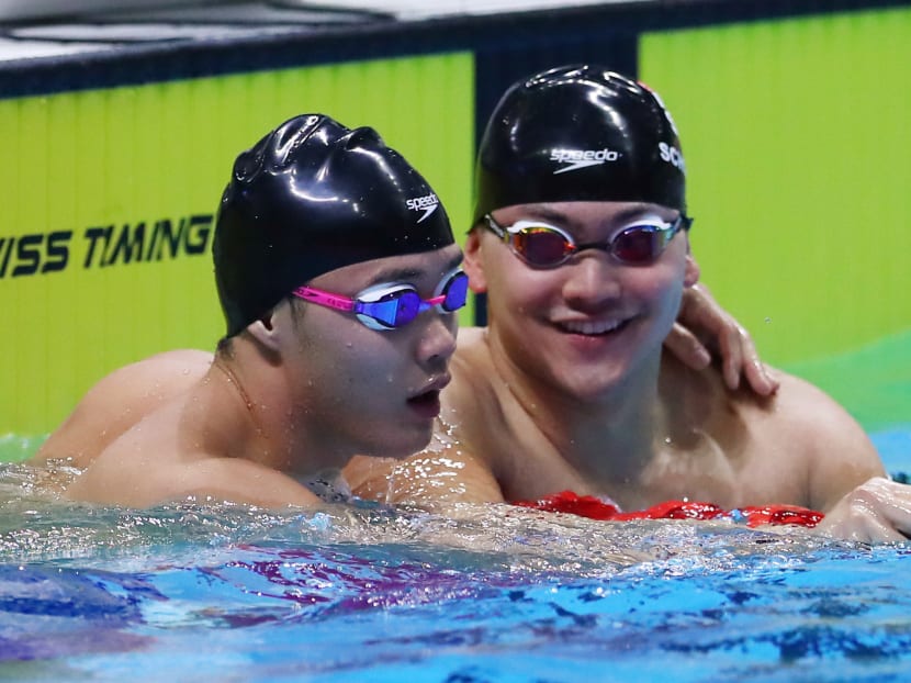 Singaporean swimmers  Teong Tzen Wei (left) and Joseph Schooling after the 50m fly butterfly final at SEA Games 2019.