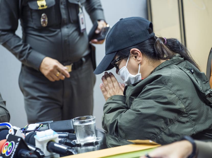 The mother of a victim of a sex trafficking ring (C) greeting a high-ranking police official at the police officials during an inquiry at the police headquarters office in Bangkok. Photo: AFP