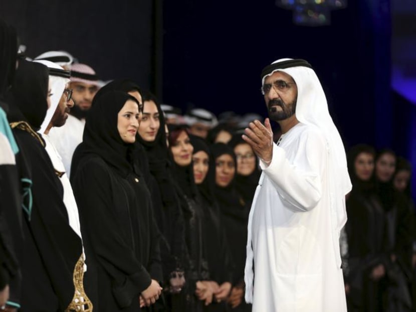 Sheikh Mohammed  Rashid Al Maktoum, Vice-President and Prime Minister of the UAE and Ruler of Dubai, talks with engineers and scientists during a ceremony to unveil UAE's Mars Mission. Photo: Reuters