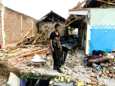A man is standing in front of his house, which is damaged by a tornado disaster in Sumedang, Indonesia, on Feb 22, 2024. 
