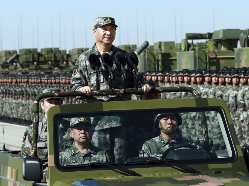 Chinese President Xi Jinping stands on a military jeep as he inspects troops of the People's Liberation Army during a military parade to commemorate the 90th anniversary of the founding of the PLA at Zhurihe training base in north China's Inner Mongolia Autonomous Region. AP file photo via Xinhua