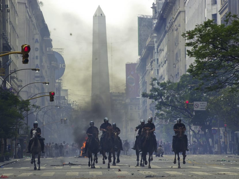 In this Dec 20, 2001 file photo, mounted police charge anti-government demonstrators in Buenos Aires, Argentina, after the South American nation had just defaulted on more than US$100 billion in foreign debt, banks were shuttered, the economy was in ruins and streets were filled with pot-banging protesters whose chants of "throw them all out" sent five presidents packing. Photo: AP