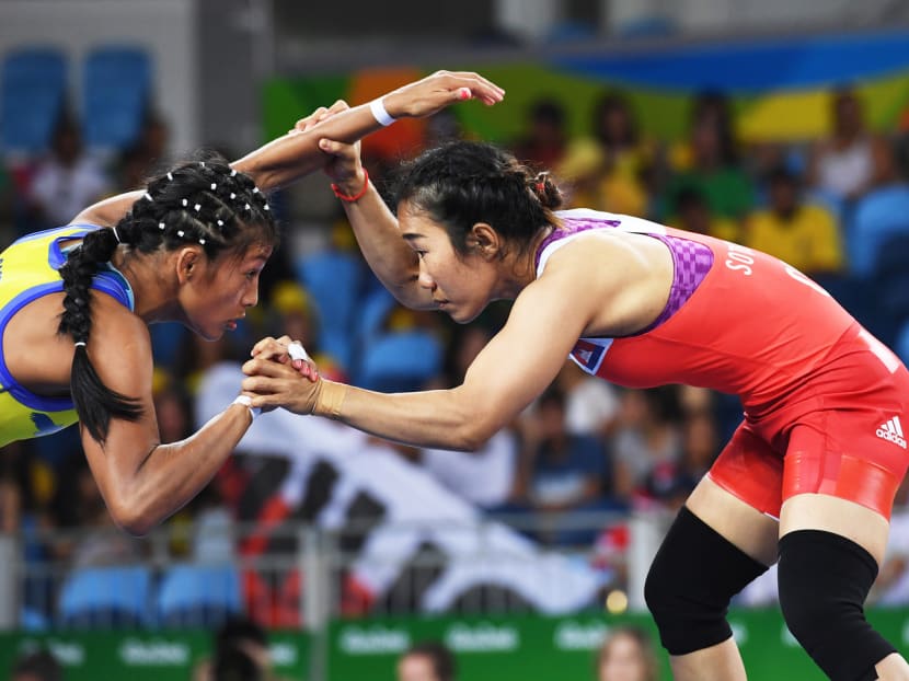Cambodia’s Chov Sotheara (right) wrestling Colombia’s Castillo Hidalgo Carolina in their women’s 48kg qualification match on Aug 17, during the 2016 Olympic Games in Rio de Janeiro, Brazil. Women make up only 25 per cent of Cambodia’s top athletes. Photo: AFP