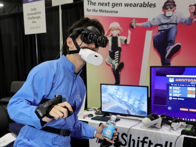 Tomohiko Fukaya demonstrates Shiftall's full-body tracking device, including the mutalk Bluetooth microphone over his mouth and FlipVR controllers, for playing VR in the metaverse during a press event at CES 2023 at the Mandalay Bay Convention Center on Jan 3, 2023 in Las Vegas, Nevada. 