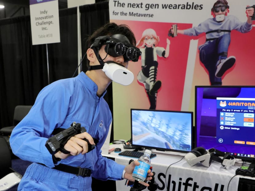 Tomohiko Fukaya demonstrates Shiftall's full-body tracking device, including the mutalk Bluetooth microphone over his mouth and FlipVR controllers, for playing VR in the metaverse during a press event at CES 2023 at the Mandalay Bay Convention Center on Jan 3, 2023 in Las Vegas, Nevada. Tomohiko Fukaya demonstrates Shiftall's full-body tracking device, including the mutalk Bluetooth microphone over his mouth and FlipVR controllers, for playing VR in the metaverse during a press event at CES 2023 at the Mandalay Bay Convention Center on Jan 3, 2023 in Las Vegas, Nevada.