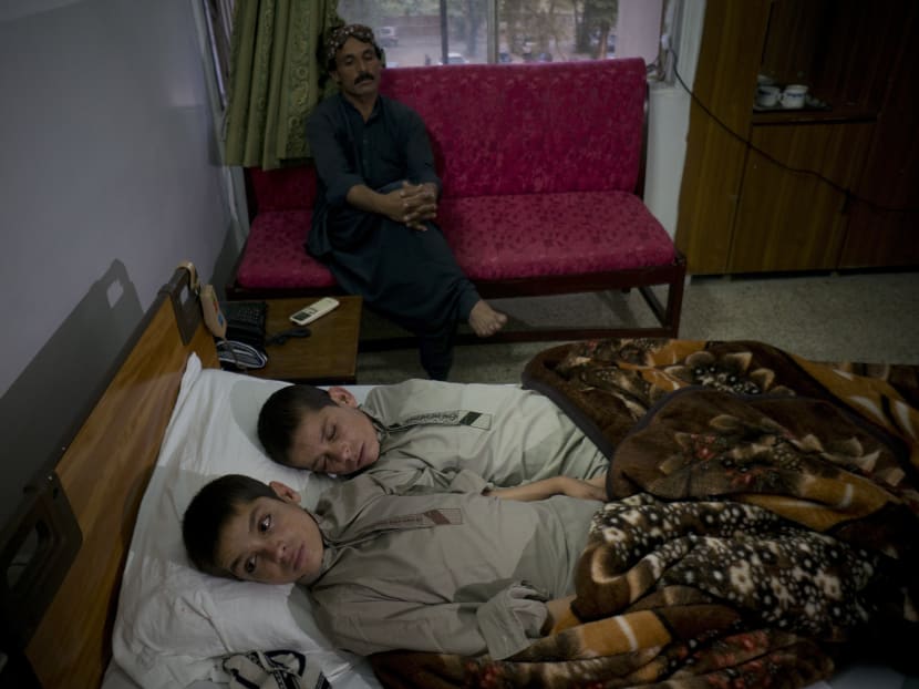 Gallery: Solar kids: Pakistan treating 2 brothers who become paralysed every night