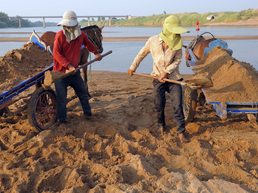 Cambodian workers shoveling sand into a horse cart along the Mekong river in Kandal province, north of Phnom Penh. China has agreed to provide information on Mekong water levels in a major boost for efforts to respond to an alarming decline in the river's flow. Photo: AFP