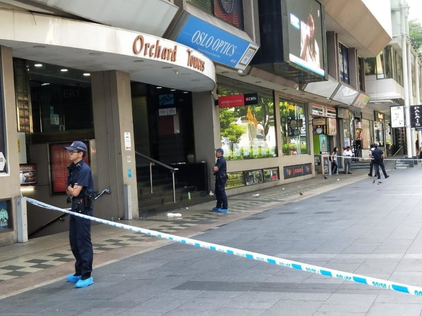 Police officers standing guard at the entrance of Orchard Towers on July 2, 2019. A man had collapsed in the building, leaving a pool of blood.