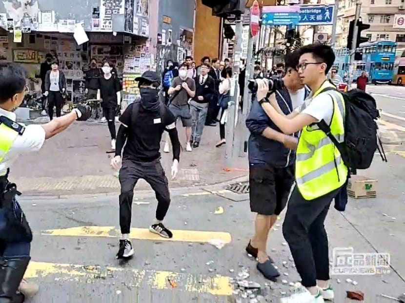 A still image from a social media video shows a police officer aiming his gun at a protester in Sai Wan Ho, Hong Kong, Nov 11, 2019.