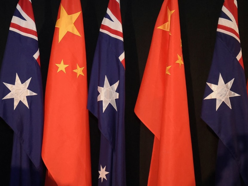 National flags of China and Australia during a signing ceremony in Canberra on June 17, 2015. China on May 6, 2021 suspended an economic agreement with Australia, worsening an already-troubled relationship fractured by spats over the Covid-19 pandemic and human rights abuses.