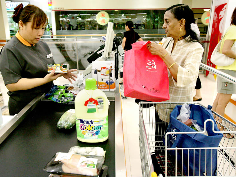 A shopper at an FairPrice supermarket. Although food prices have been buoyant, economists warn that due to financial volatility, consumers may need to be cautious. TODAY file photo