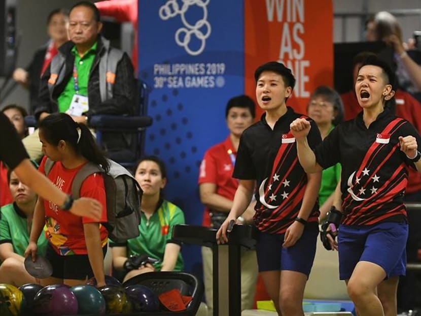 Singapore's bowlers celebrating a strike in the women's team event at the SEA Games.