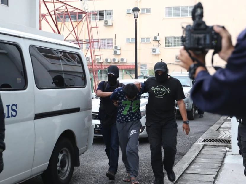 One of the members of Abu Sayyaf militant group being led by police into the Kajang Sessions Court. Photo: New Straits Times