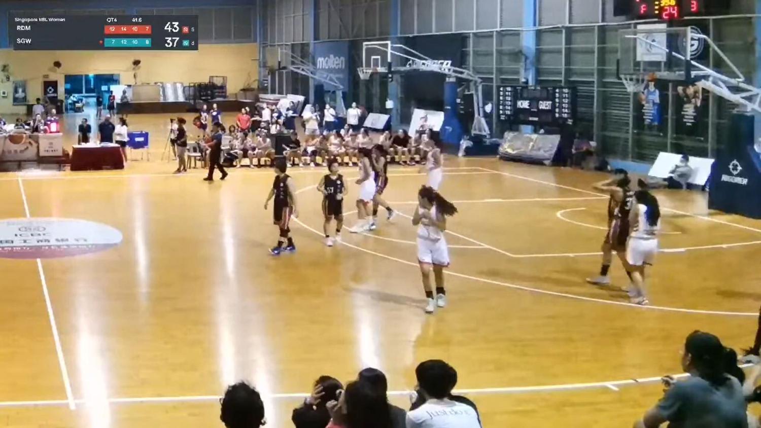 Players react after what appears to be a ceiling light crashes to the ground in front of a scorer's table during a Pennant Cup match at the Singapore Basketball Centre on Nov 12, 2022. 