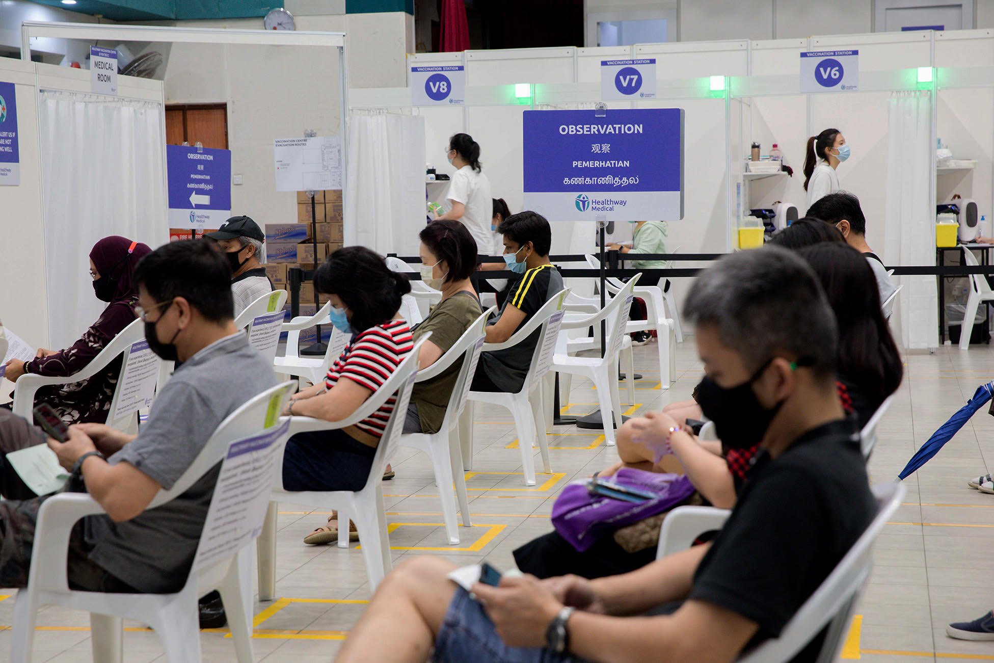 People waiting at an observation area after receiving their Covid-19 vaccines. People waiting at an observation area after receiving their Covid-19 vaccines.