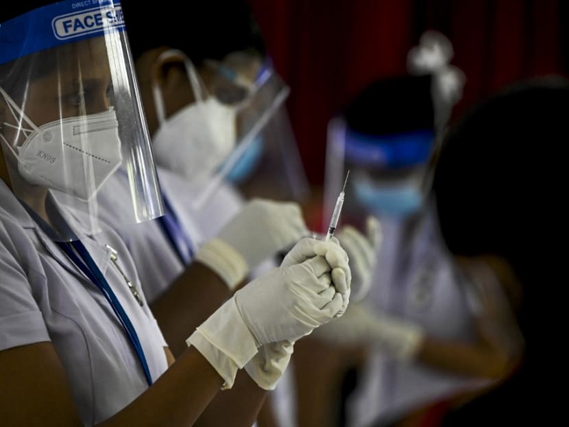 A health worker preapres to inoculate a man with a dose of the Sputnik V Covid-19 coronavirus vaccine in Colombo on May 6, 2021. A health worker preapres to inoculate a man with a dose of the Sputnik V Covid-19 coronavirus vaccine in Colombo on May 6, 2021.