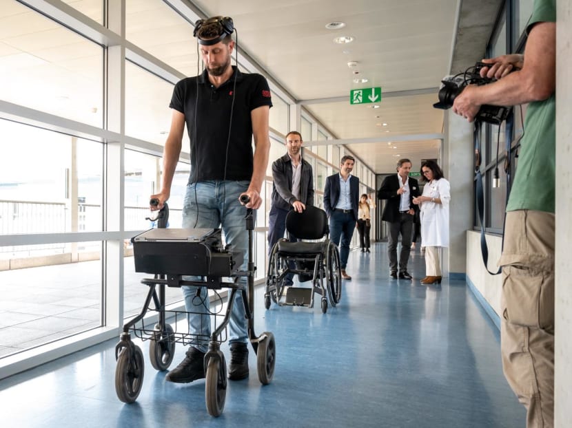 Mr Gert-Jan, 40, victim of a spinal cord injury that left him paralysed, walks with his implants during a press conference in Lausanne on May 23, 2023.