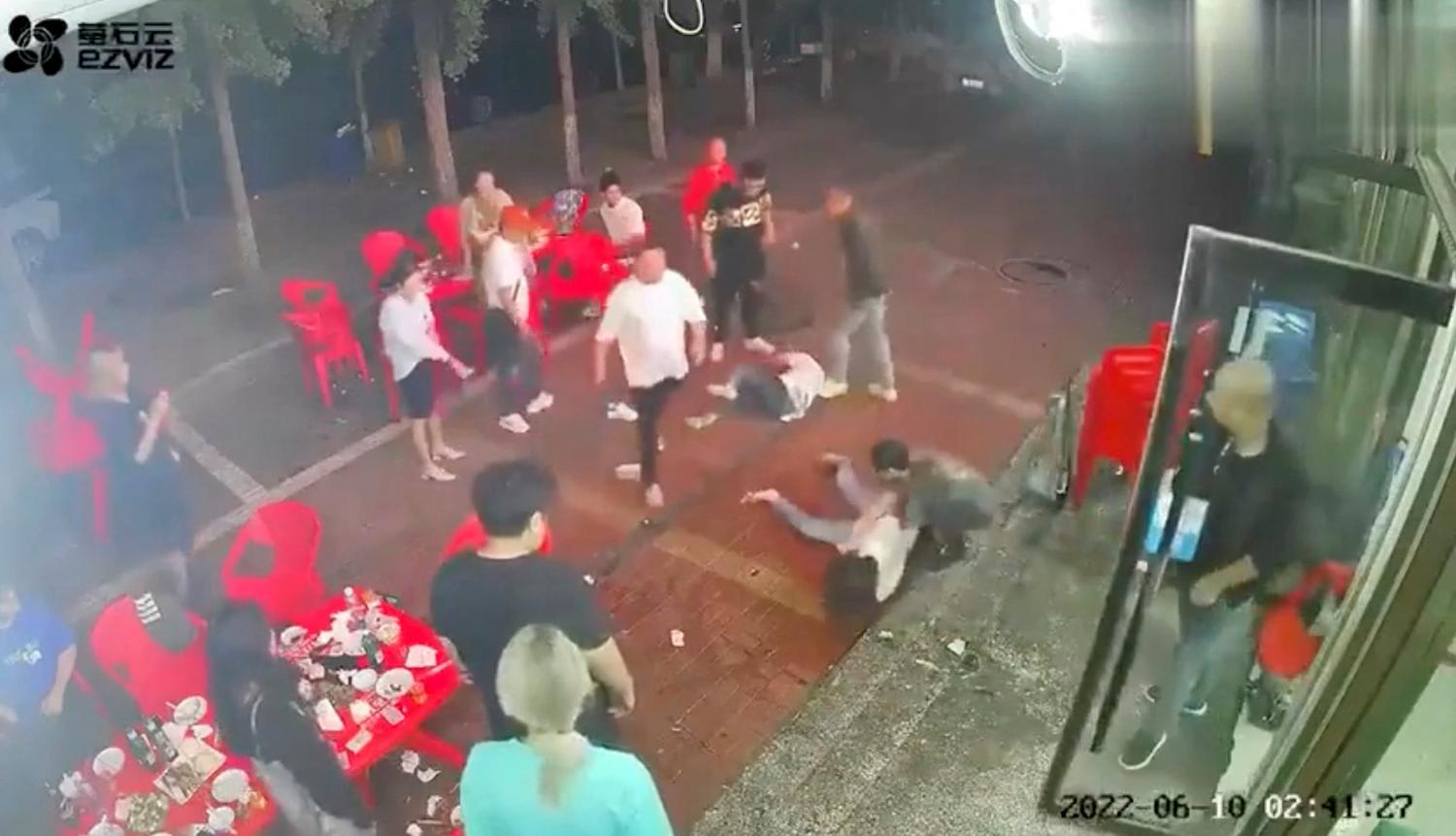 Two women lie on the ground after being assaulted by a group of men outside a restaurant in the northeastern city of Tangshan on June 10, 2022. Two women lie on the ground after being assaulted by a group of men outside a restaurant in the northeastern city of Tangshan on June 10, 2022.