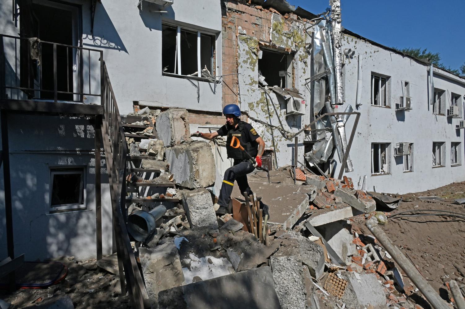 A Ukrainian deminer climb debris near the damaged building of a clinical medical laboratory following a Russian rocket strike in the second largest Ukrainian city of Kharkiv on Aug 9, 2022. A Ukrainian deminer climb debris near the damaged building of a clinical medical laboratory following a Russian rocket strike in the second largest Ukrainian city of Kharkiv on Aug 9, 2022.