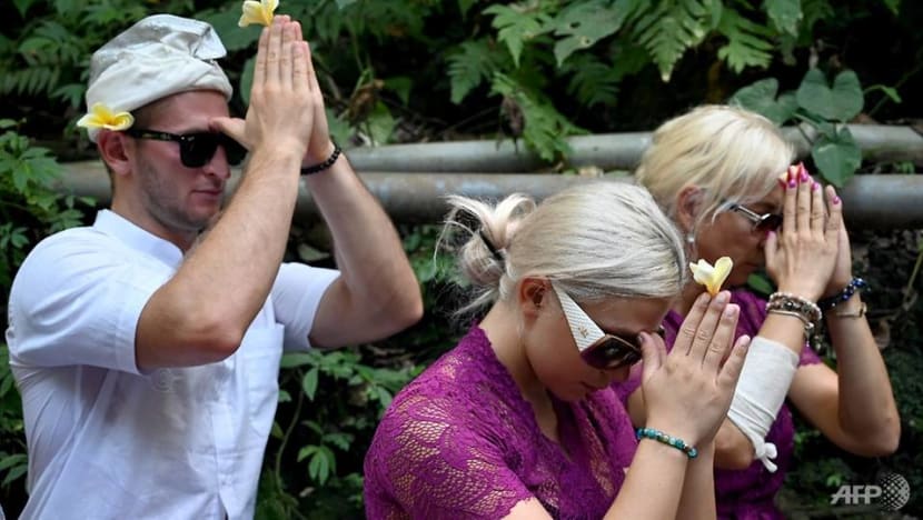 Czech couple pray in cleansing ritual after Bali temple antics