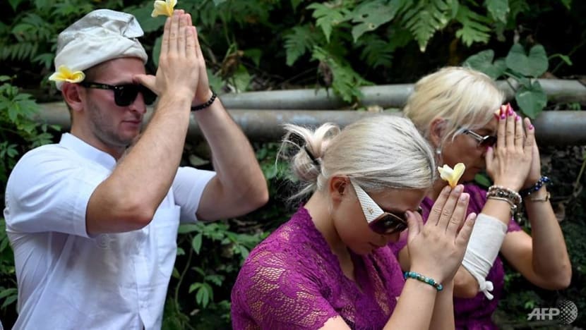 Czech couple pray in cleansing ritual after Bali temple antics Czech couple pray in cleansing ritual after Bali temple antics