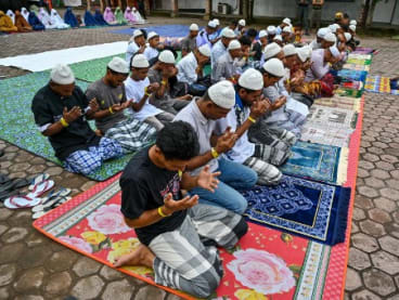 Rohingya refugees take part in Eid al-Fitr prayers, marking the end of the holy month of Ramadan, at a temporary shelter in Meulaboh, Indonesia's Aceh province on April 10, 2024.