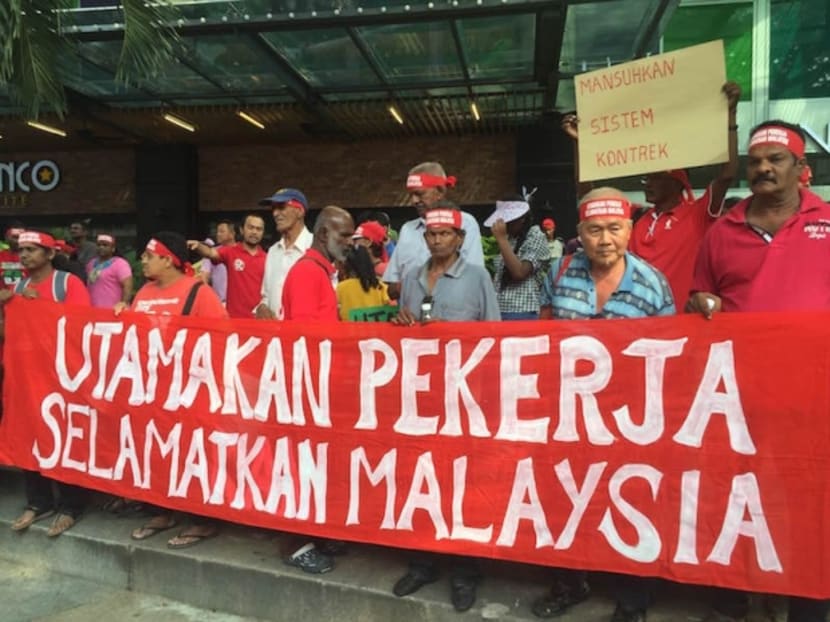 Rally participants hold a banner outside Maju Junction Mall in Kuala Lumpur May 1, 2016. Photo: Malay Mail Online