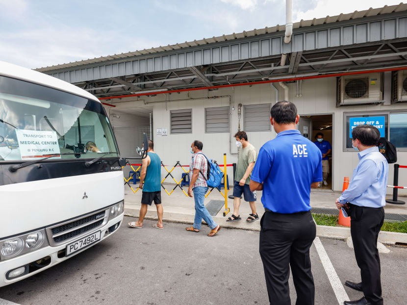 Workers residing at Westlite Jalan Tukang dormitory in Jurong being taken by transport to get medical consultations at a regional medical centre.