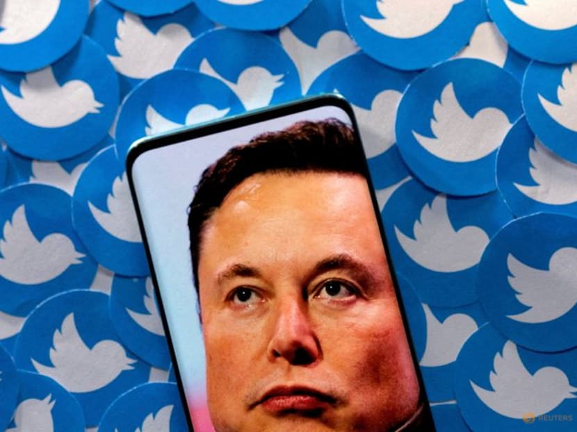 FILE PHOTO: An image of Elon Musk is seen on smartphone placed on printed Twitter logos in this picture illustration taken April 28, 2022. REUTERS/Dado Ruvic/Illustration/File Photo
