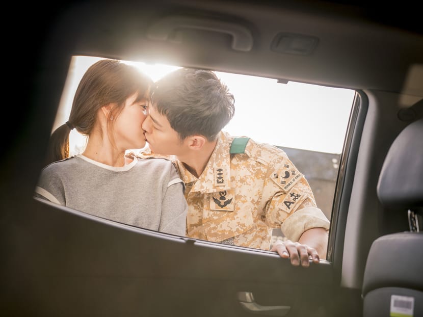 This undated handout photo released by Next Entertainment World in Seoul on April 5, 2016 shows South Korean actor Song Joong-Ki (R) and actress Song Hye-Kyo in a scene from the hit South Korean drama series "Descendants of the Sun". Photo via AFP