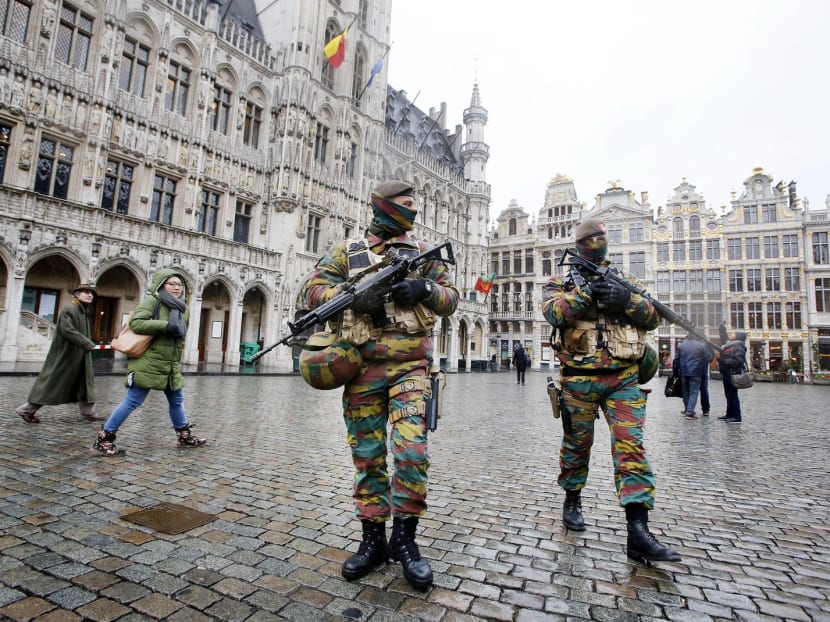 Belgian police officers patrol the Grand Place in central Brussels, Belgium, on Tuesday. A few bars and restaurants in the city were open for business, but they were struggling to find customers. Photo: AP