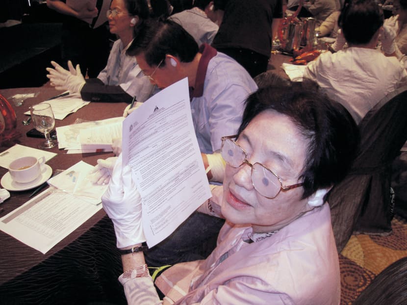 Healthcare professionals read and fill forms with ‘diminished’ eyesight and hearing during an earlier age-sensitisation workshop. PHOTO COURTESY SINGHEALTH
